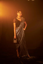 Load image into Gallery viewer, Saia metallic slit saree with an embellished pearl blouse will definitely make you look sassy and elegant in an event.  Tailored to perfection in a metallic fabric, the saree features a slit from the waist level and has an attached palla which creates a great fall.  It comes with a pearl embellished blouse with a deep V-neckline and ruffle sleeves in organza and deep from the back.