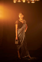 Load image into Gallery viewer, Saia metallic slit saree with an embellished pearl blouse will definitely make you look sassy and elegant in an event.  Tailored to perfection in a metallic fabric, the saree features a slit from the waist level and has an attached palla which creates a great fall.  It comes with a pearl embellished blouse with a deep V-neckline and ruffle sleeves in organza and deep from the back.